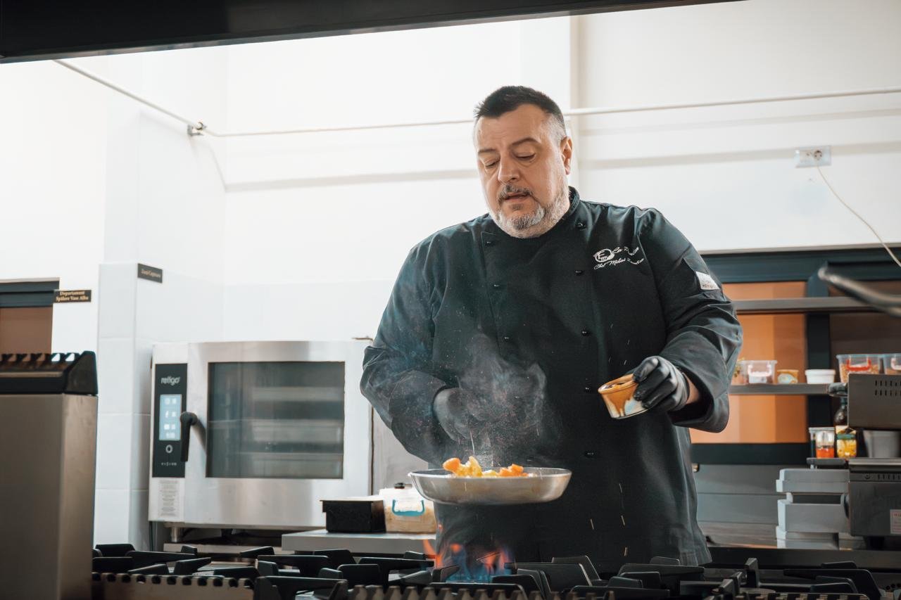 Chef Zamfira Mihai pregătind un preparat într-o bucătărie profesională